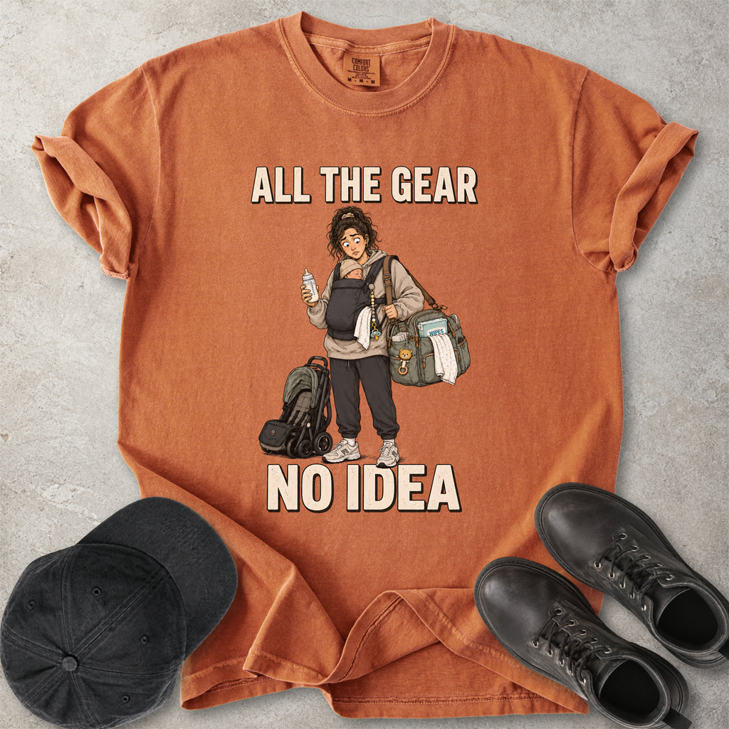 Orange yam Comfort Colors 1717 T-shirt with a funny All the Gear No Idea new mum graphic showing a tired mother carrying a baby, bottle, changing bag and stroller.