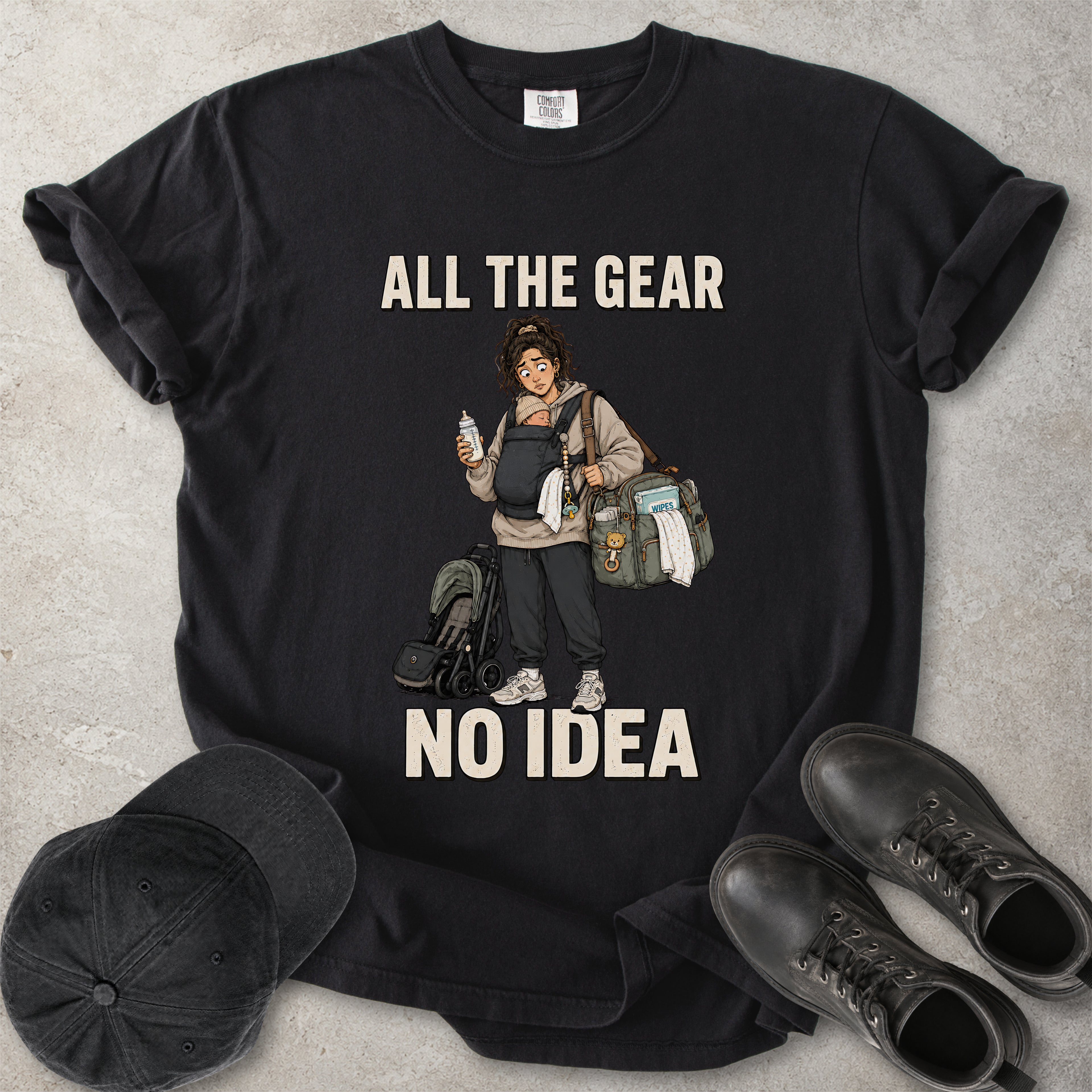 Black Comfort Colors 1717 T-shirt with a funny All the Gear No Idea new mum graphic showing a tired mother carrying a baby, bottle, changing bag and stroller.