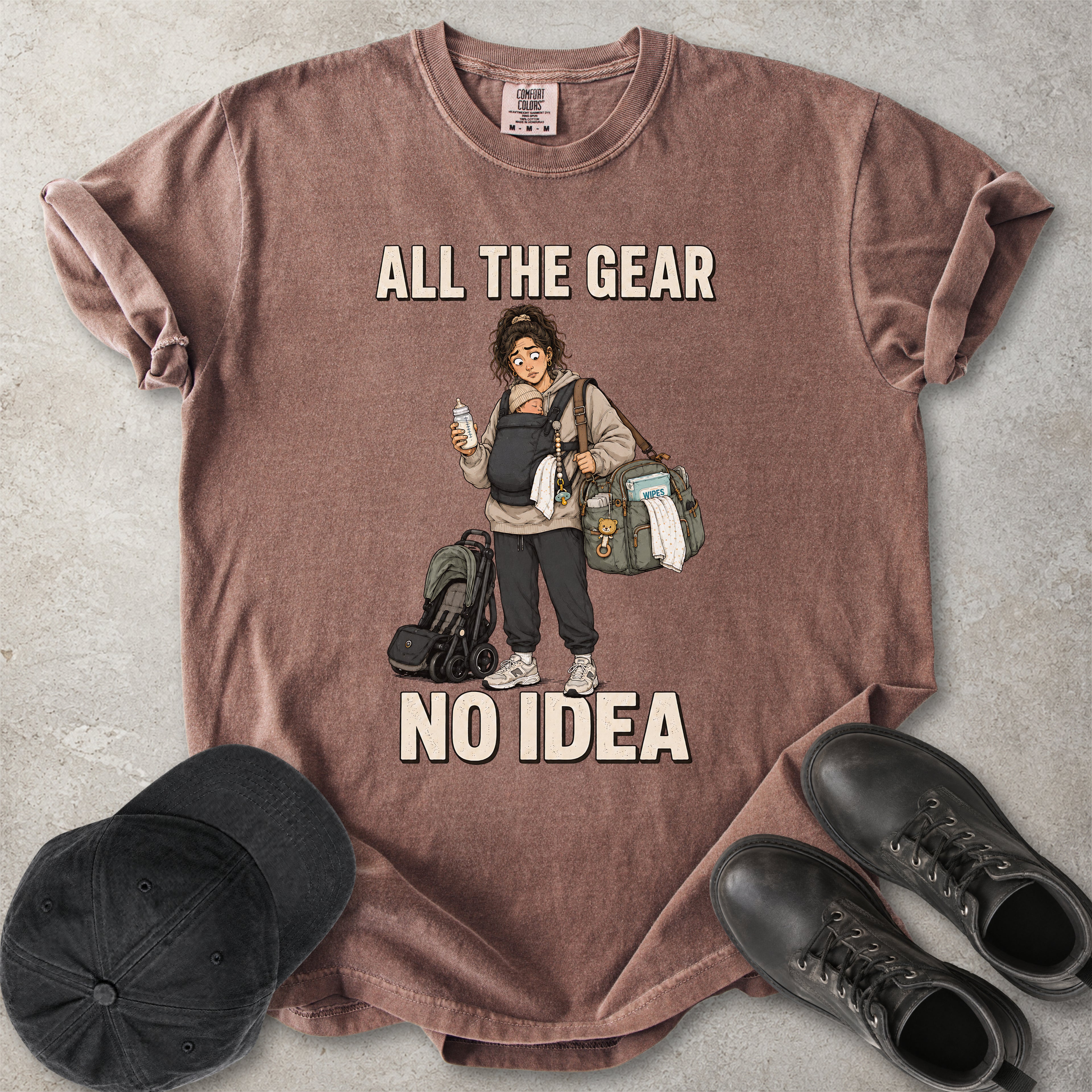 Espresso brown Comfort Colors 1717 T-shirt with a funny All the Gear No Idea new mum graphic showing a tired mother carrying a baby, bottle, changing bag and stroller.