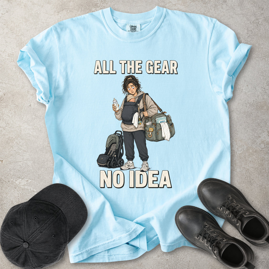 Chambray light blue Comfort Colors 1717 T-shirt with a funny All the Gear No Idea new mum graphic showing a tired mother carrying a baby, bottle, changing bag and stroller.