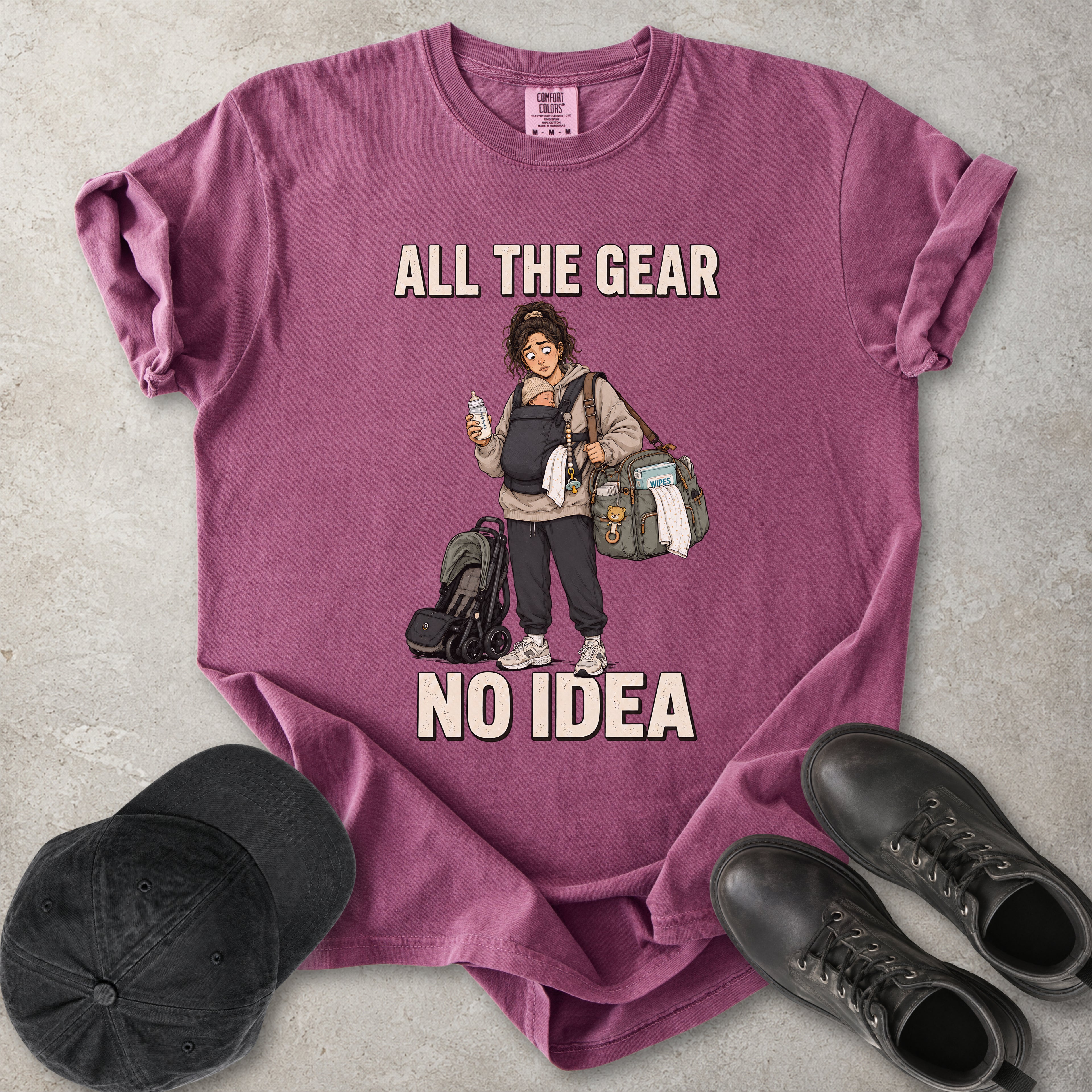 Berry purple Comfort Colors 1717 T-shirt with a funny All the Gear No Idea new mum graphic showing a tired mother carrying a baby, bottle, changing bag and stroller.