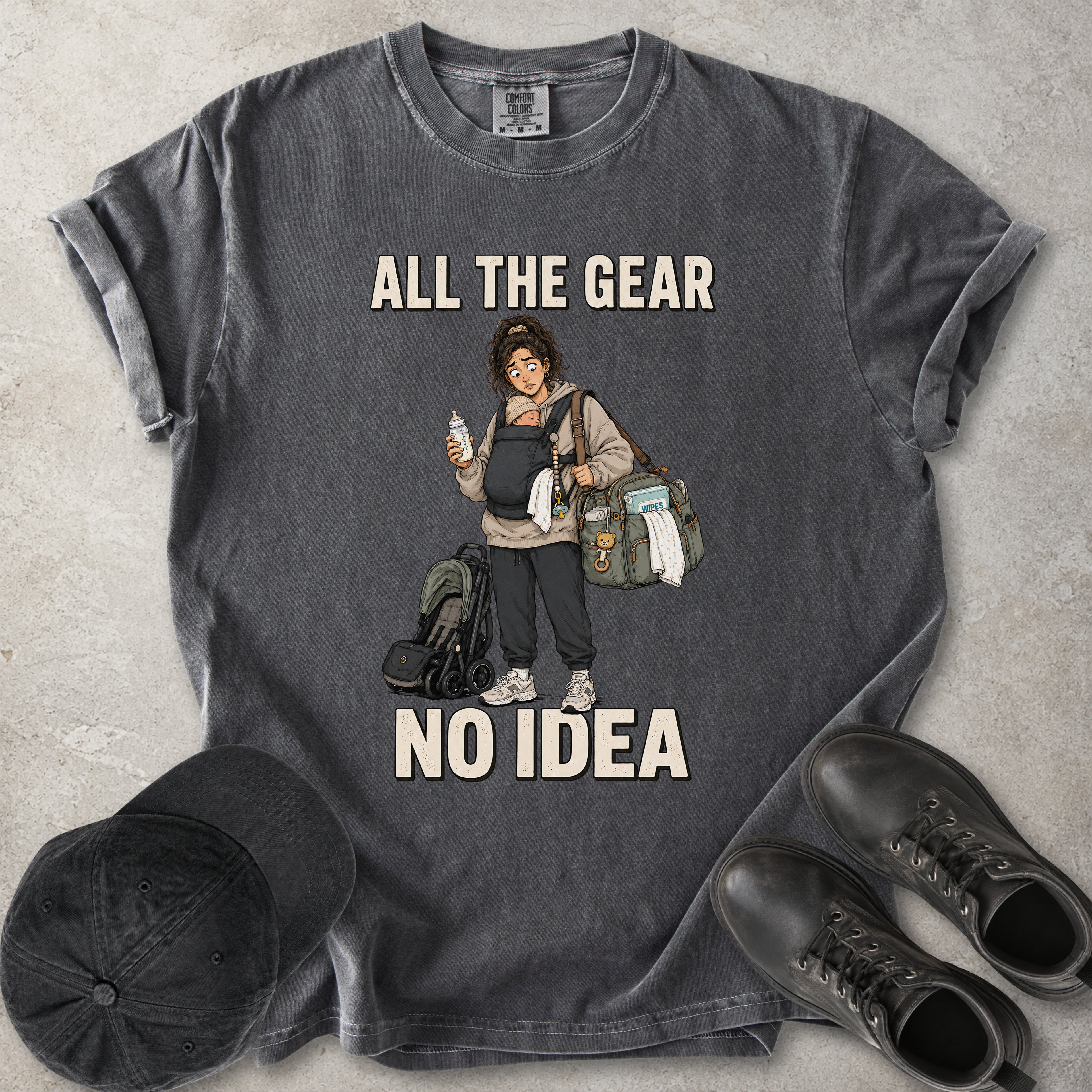 Pepper grey Comfort Colors 1717 T-shirt with a funny All the Gear No Idea new mum graphic showing a tired mother carrying a baby, bottle, changing bag and stroller.