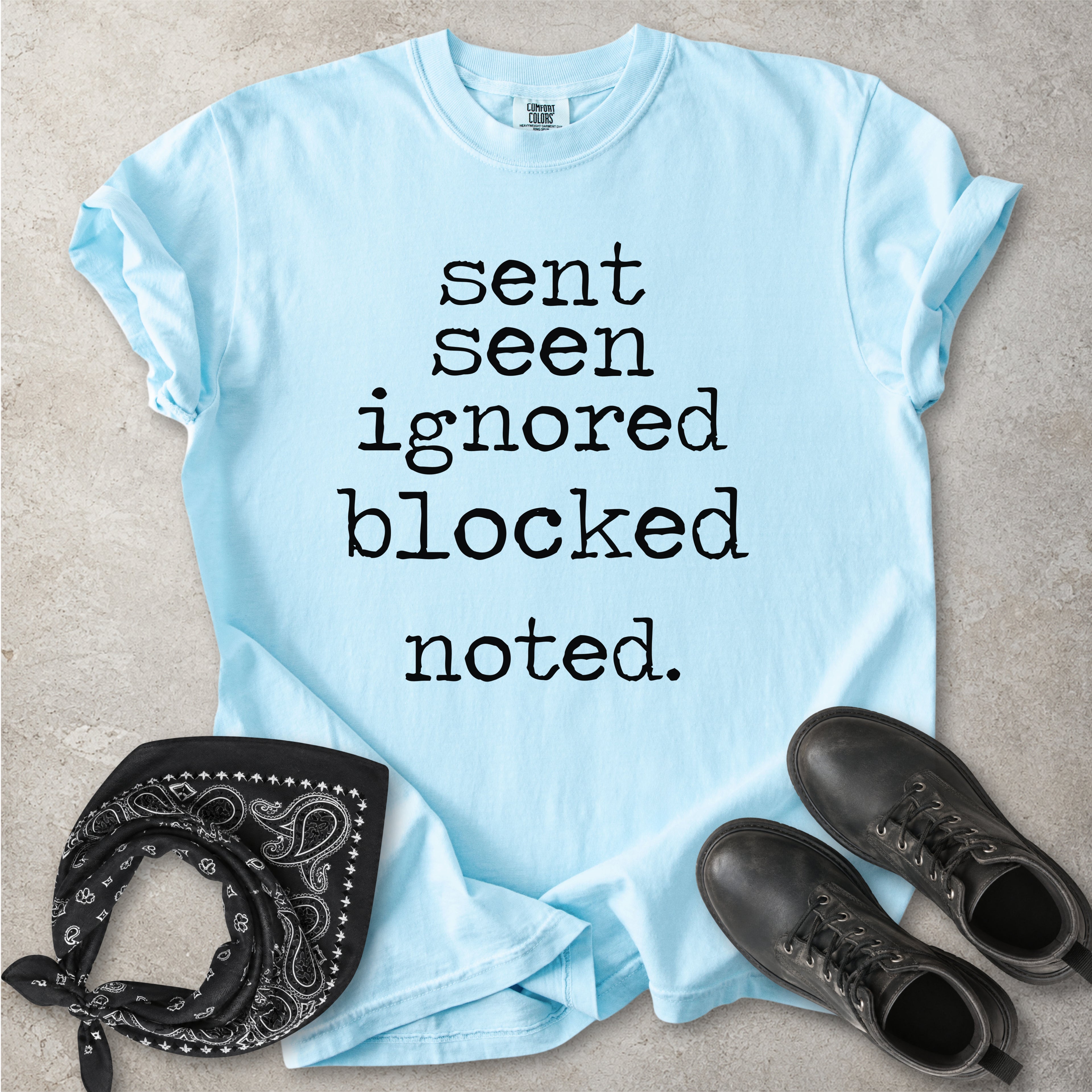 Chambray light blue Comfort Colors graphic T-shirt with black text reading sent seen ignored blocked noted, styled with black boots and a black bandana