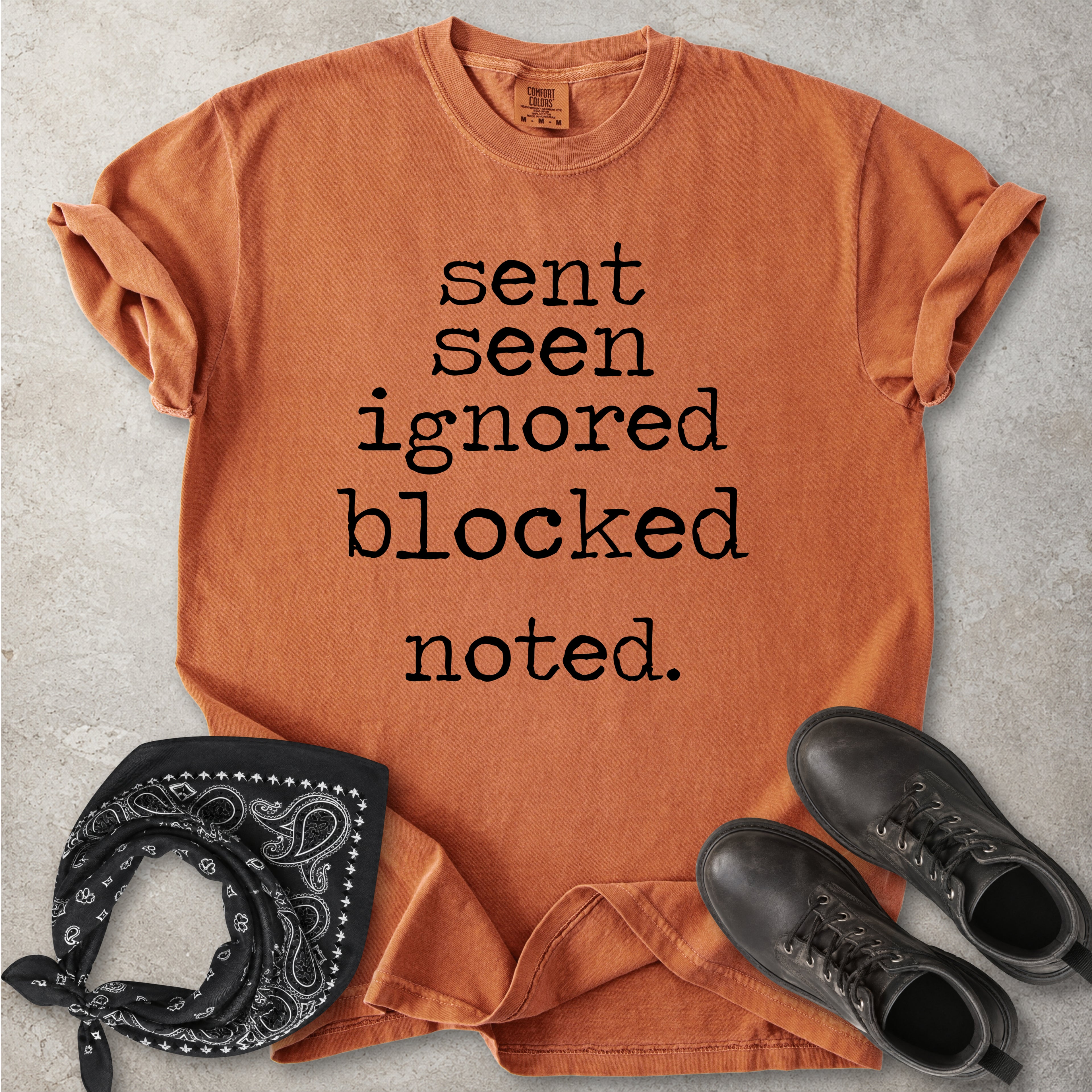 Yam orange Comfort Colors graphic T-shirt with black text reading sent seen ignored blocked noted, styled with black boots and a black bandana