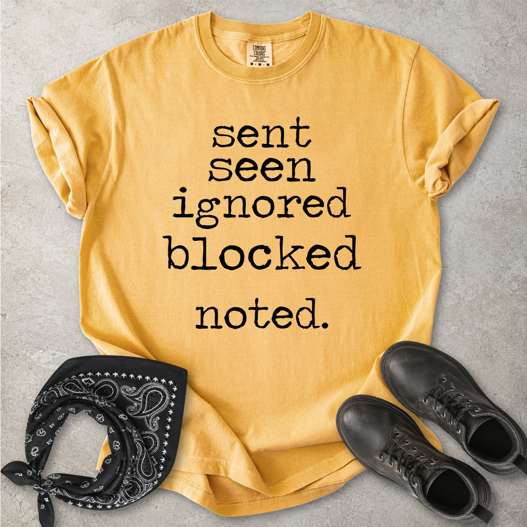 Mustard yellow Comfort Colors graphic T-shirt with black text reading sent seen ignored blocked noted, styled with black boots and a black bandana