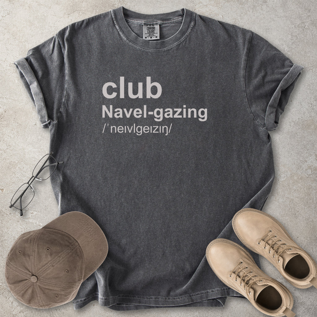 Pepper grey Comfort Colors graphic T-shirt with grey text reading club navel-gazing, styled with notebook, pen, glasses and tan boots
