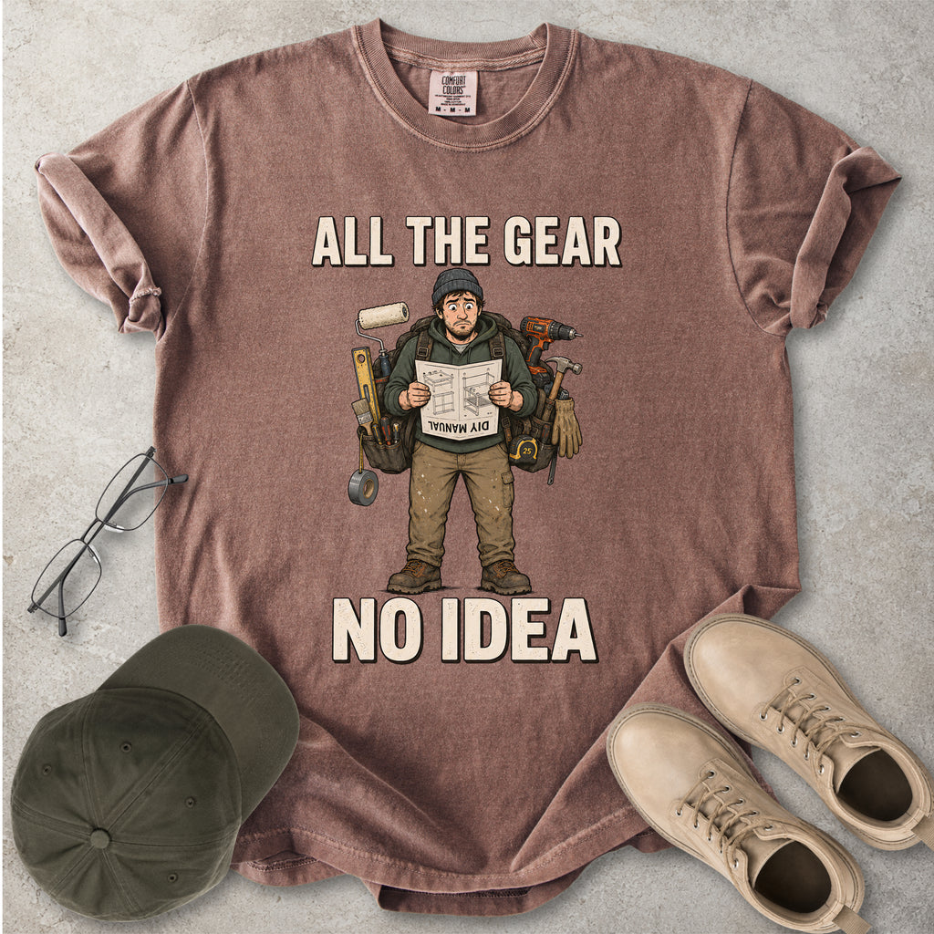 Espresso brown Comfort Colors 1717 T-shirt with a funny All the Gear No Idea DIY graphic showing a confused handyman carrying tools and reading a manual.