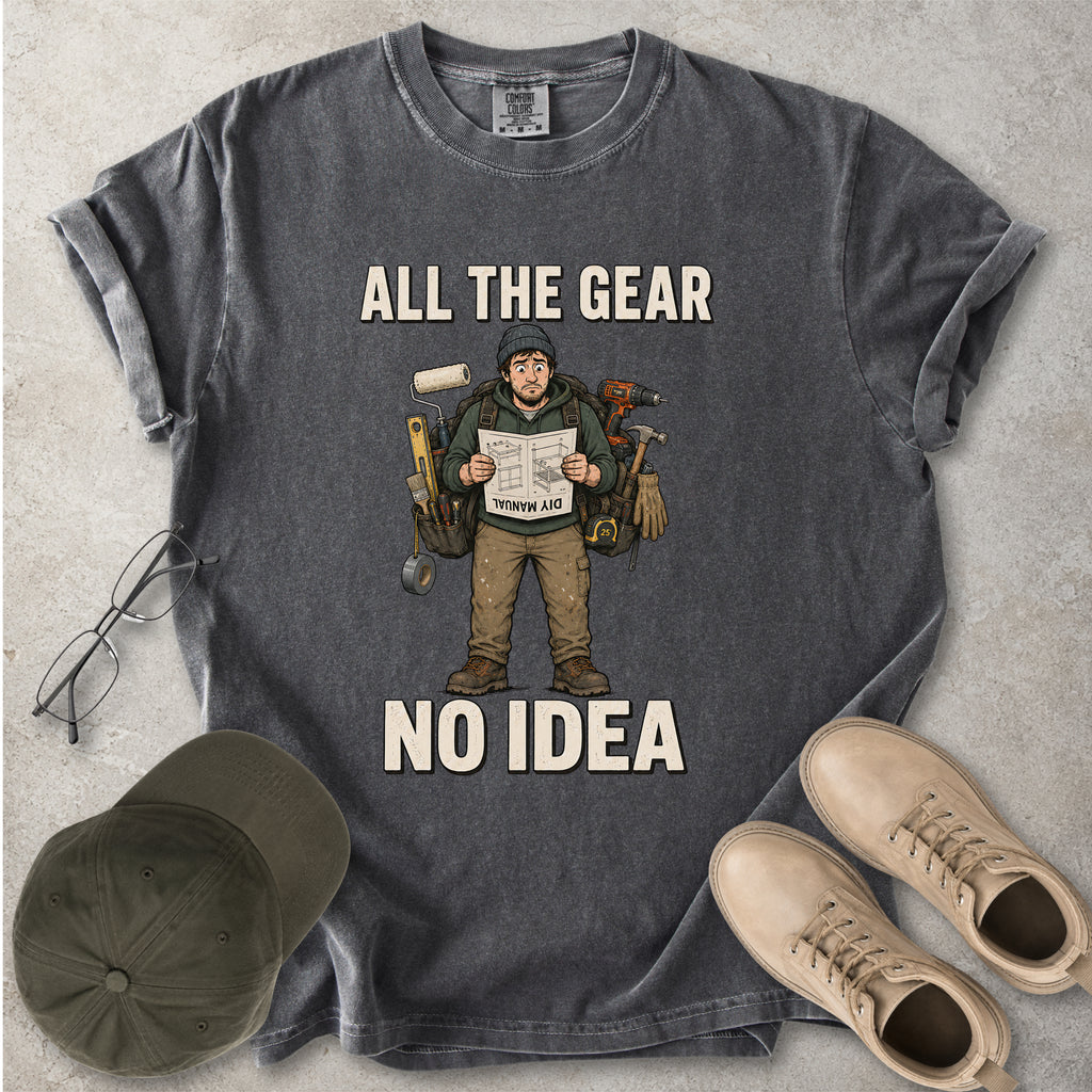 Pepper grey Comfort Colors 1717 T-shirt with a funny All the Gear No Idea DIY graphic showing a confused handyman carrying tools and reading a manual.
