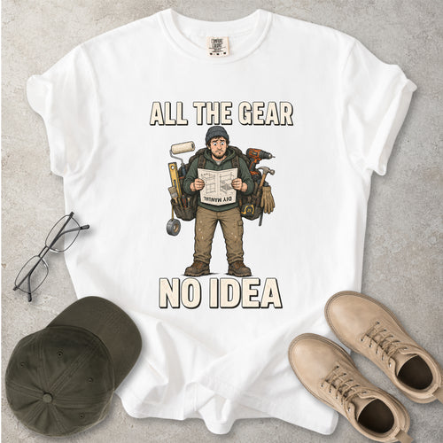 White Comfort Colors 1717 T-shirt with a funny All the Gear No Idea DIY graphic showing a confused handyman carrying tools and reading a manual.