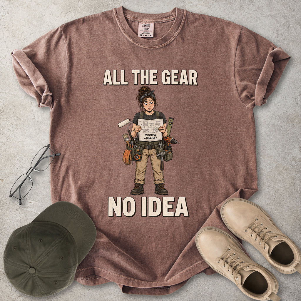 Espresso brown Comfort Colors 1717 T-shirt with a funny All the Gear No Idea DIY graphic showing a woman with tools holding an upside-down assembly manual.