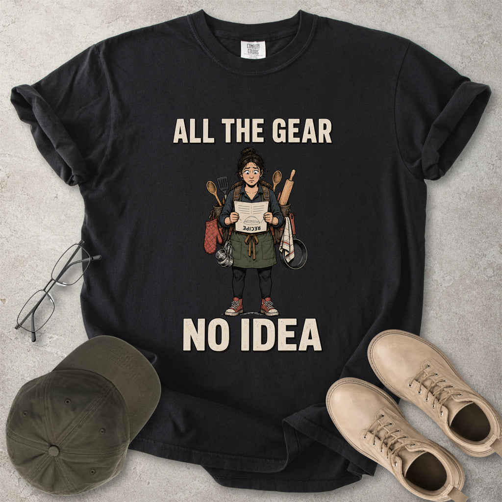 Black Comfort Colors 1717 T-shirt with a funny All the Gear No Idea cooking graphic showing a woman holding an upside-down recipe with kitchen utensils.