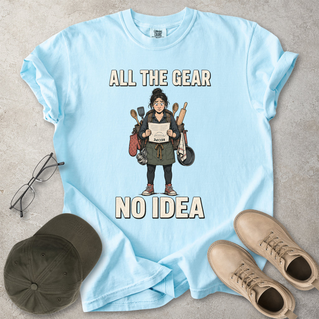 Chambray light blue Comfort Colors 1717 T-shirt with a funny All the Gear No Idea cooking graphic showing a woman holding an upside-down recipe with kitchen utensils.