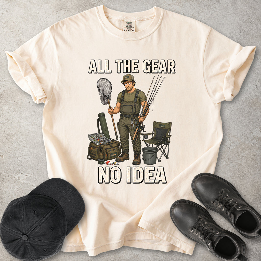 Ivory beige Comfort Colors 1717 T-shirt with a funny All the Gear No Idea fishing graphic showing a confused fisherman holding rods and a landing net with fishing gear.