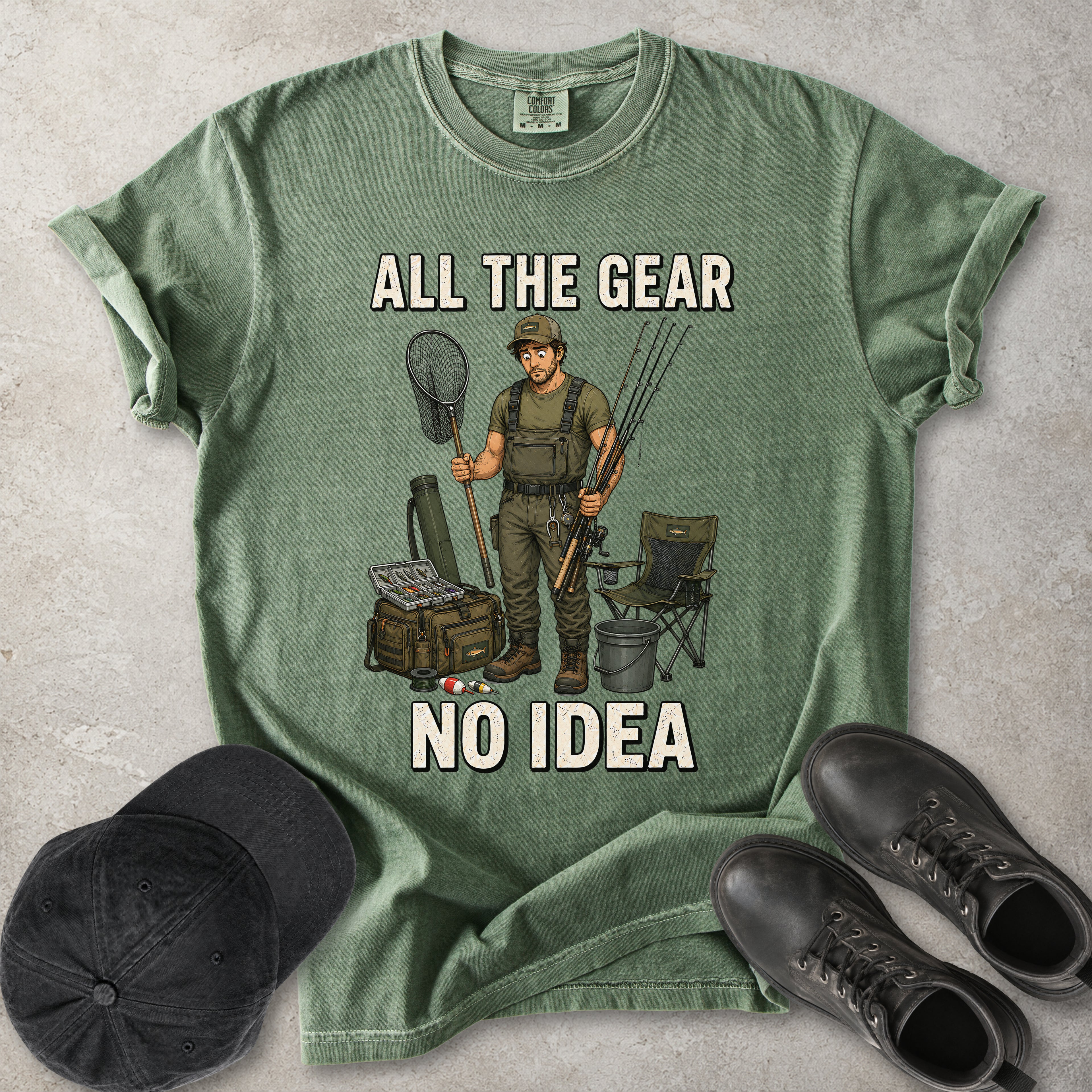 Moss green Comfort Colors 1717 T-shirt with a funny All the Gear No Idea fishing graphic showing a confused fisherman holding rods and a landing net with fishing gear.