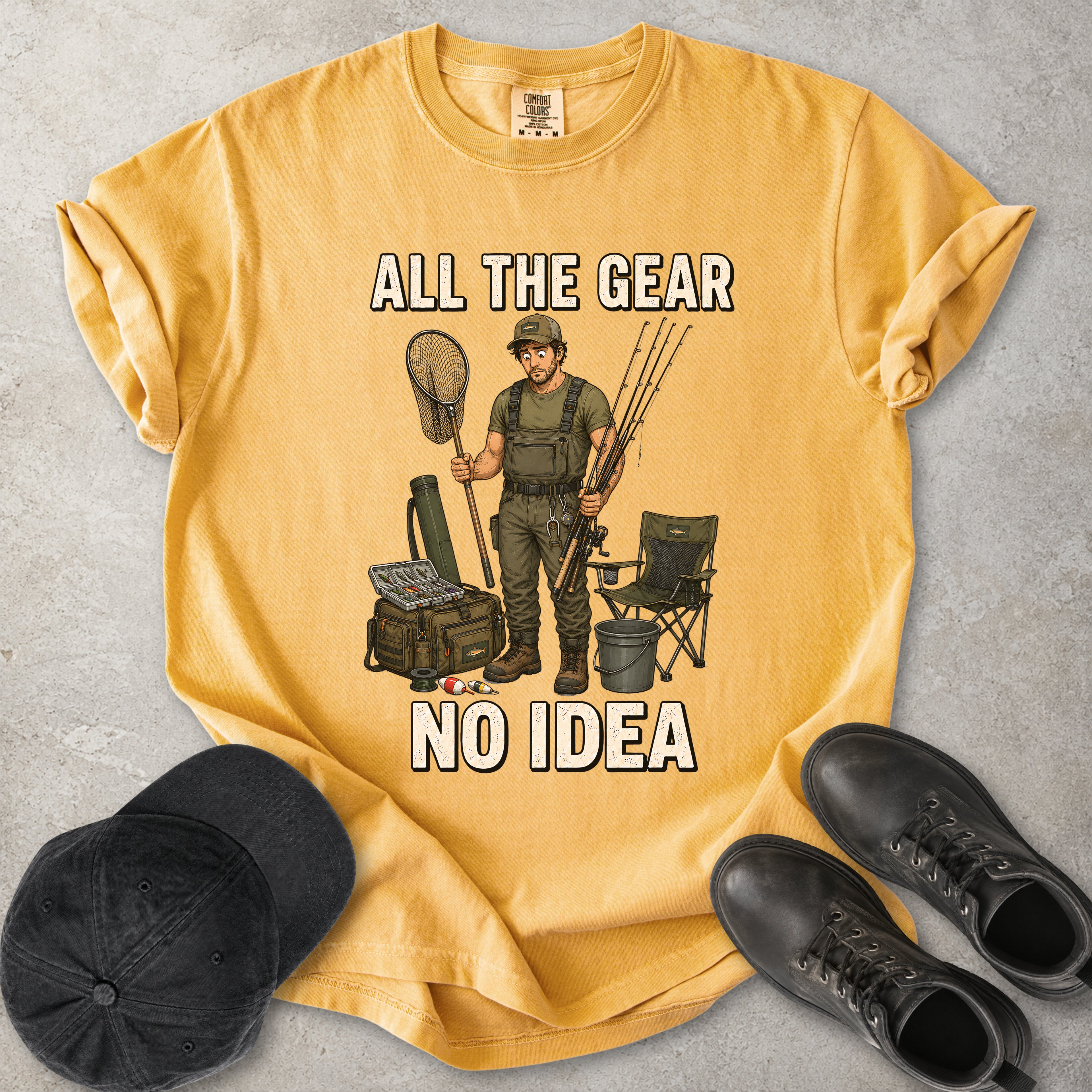 Mustard Yellow Comfort Colors 1717 T-shirt with a funny All the Gear No Idea fishing graphic showing a confused fisherman holding rods and a landing net with fishing gear.