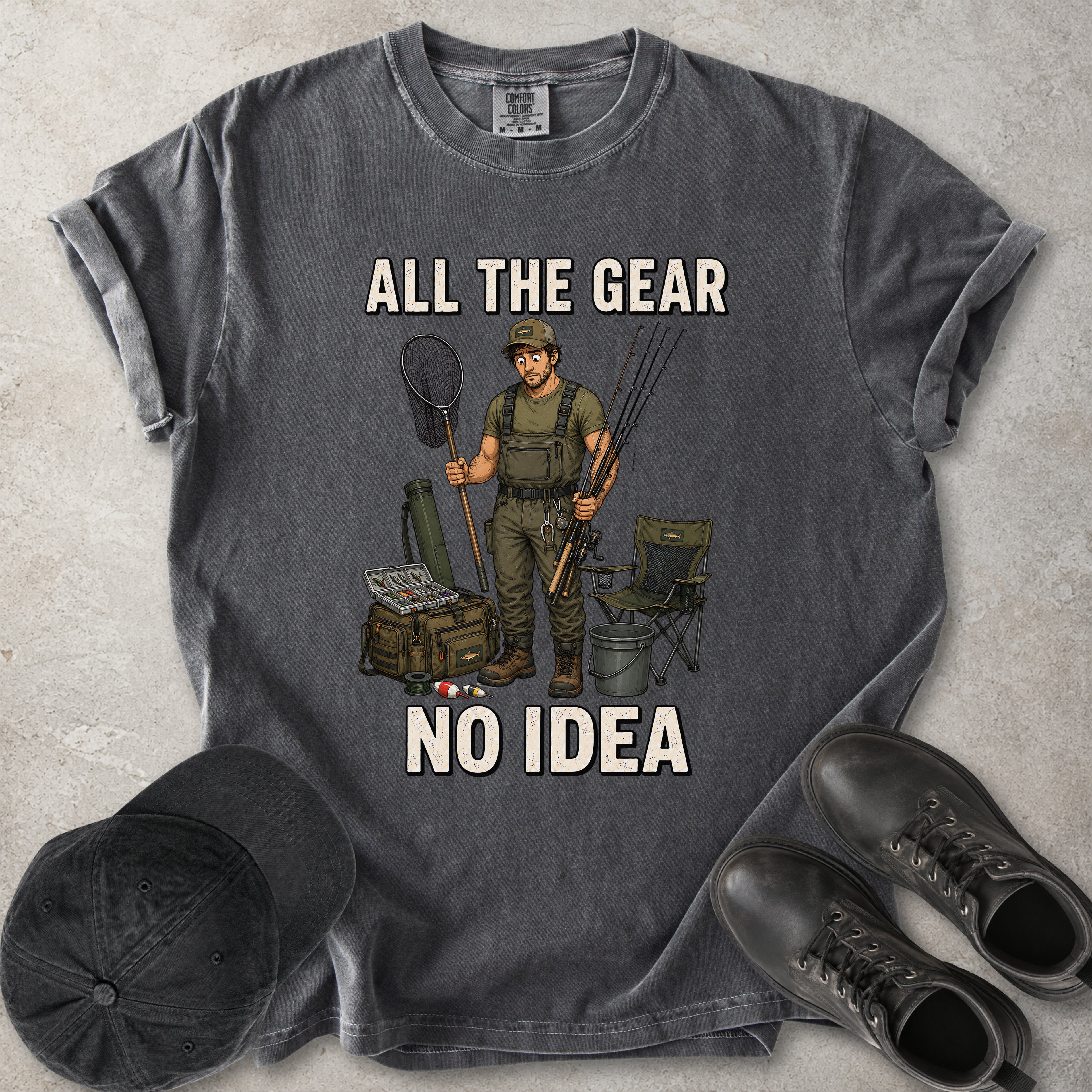 Pepper grey Comfort Colors 1717 T-shirt with a funny All the Gear No Idea fishing graphic showing a confused fisherman holding rods and a landing net with fishing gear.