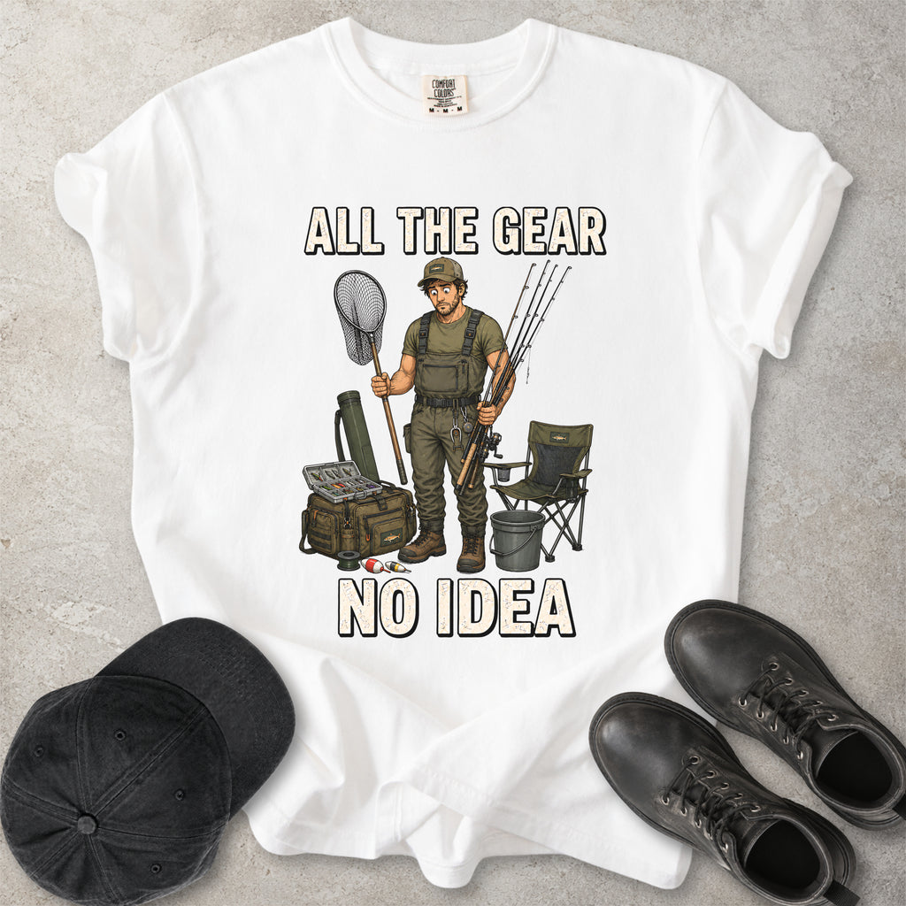 White Comfort Colors 1717 T-shirt with a funny All the Gear No Idea fishing graphic showing a confused fisherman holding rods and a landing net with fishing gear.