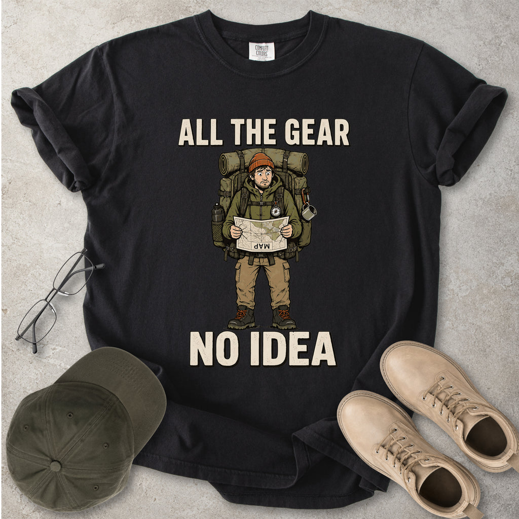 Black Comfort Colors 1717 T-shirt with a funny All the Gear No Idea hiking graphic showing a confused hiker holding an upside-down map with a large backpack.