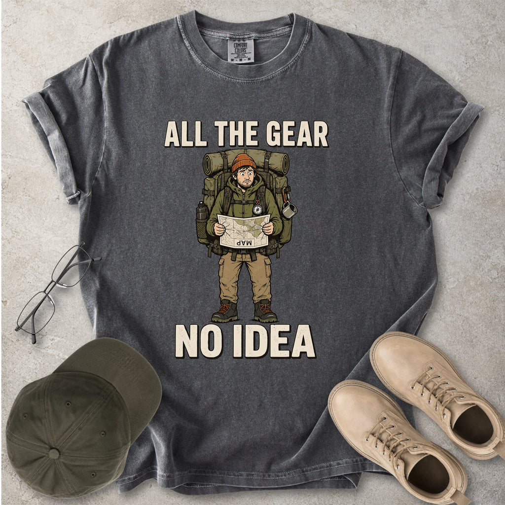 Pepper grey Comfort Colors 1717 T-shirt with a funny All the Gear No Idea hiking graphic showing a confused hiker holding an upside-down map with a large backpack.