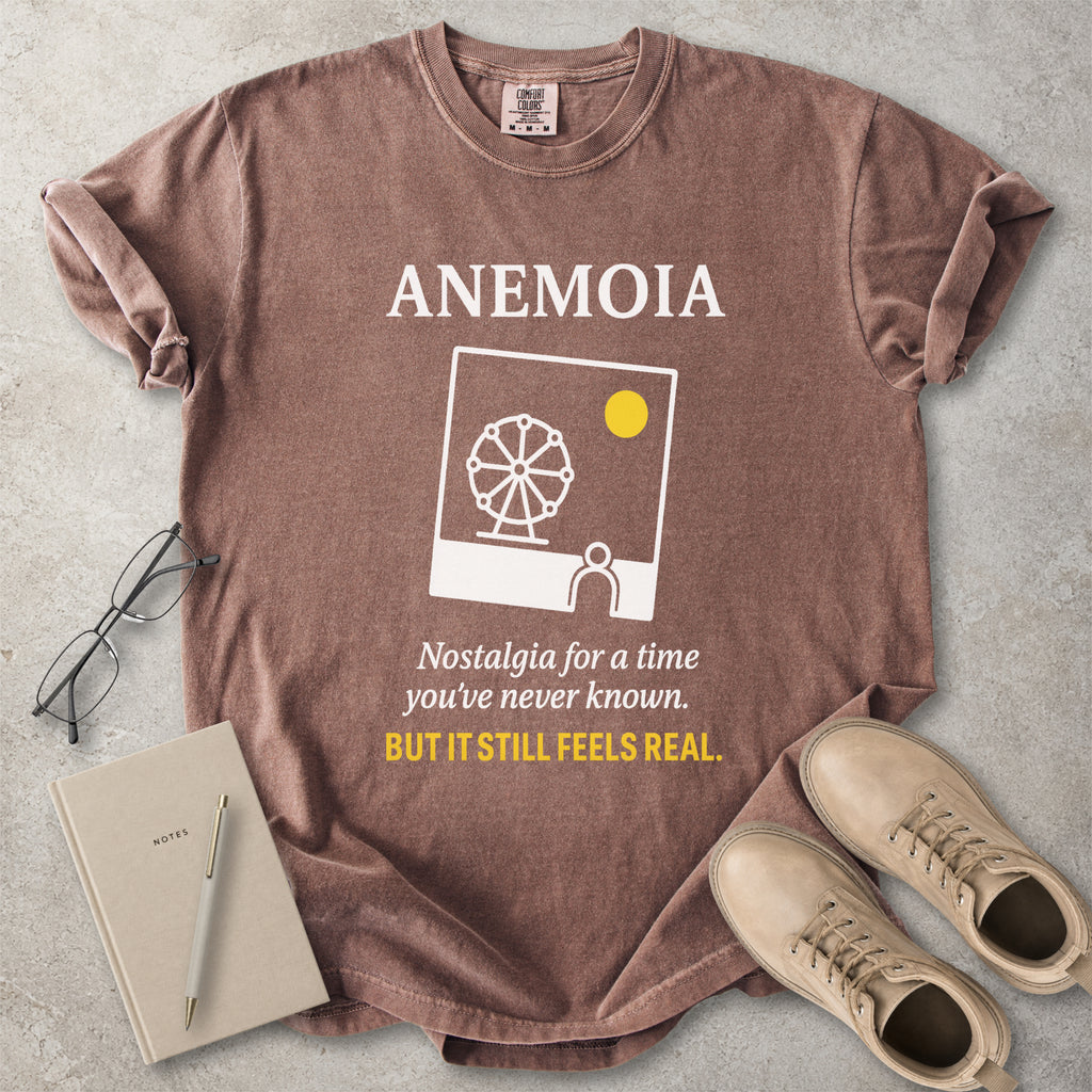 Espresso brown Comfort Colors graphic T-shirt with Anemoia text, photo-style ferris wheel design and yellow accent text, styled with notebook, glasses and tan boots