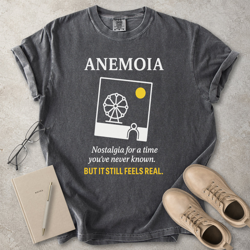 Pepper grey Comfort Colors graphic T-shirt with Anemoia text, photo-style ferris wheel design and yellow accent text, styled with notebook, glasses and tan boots
