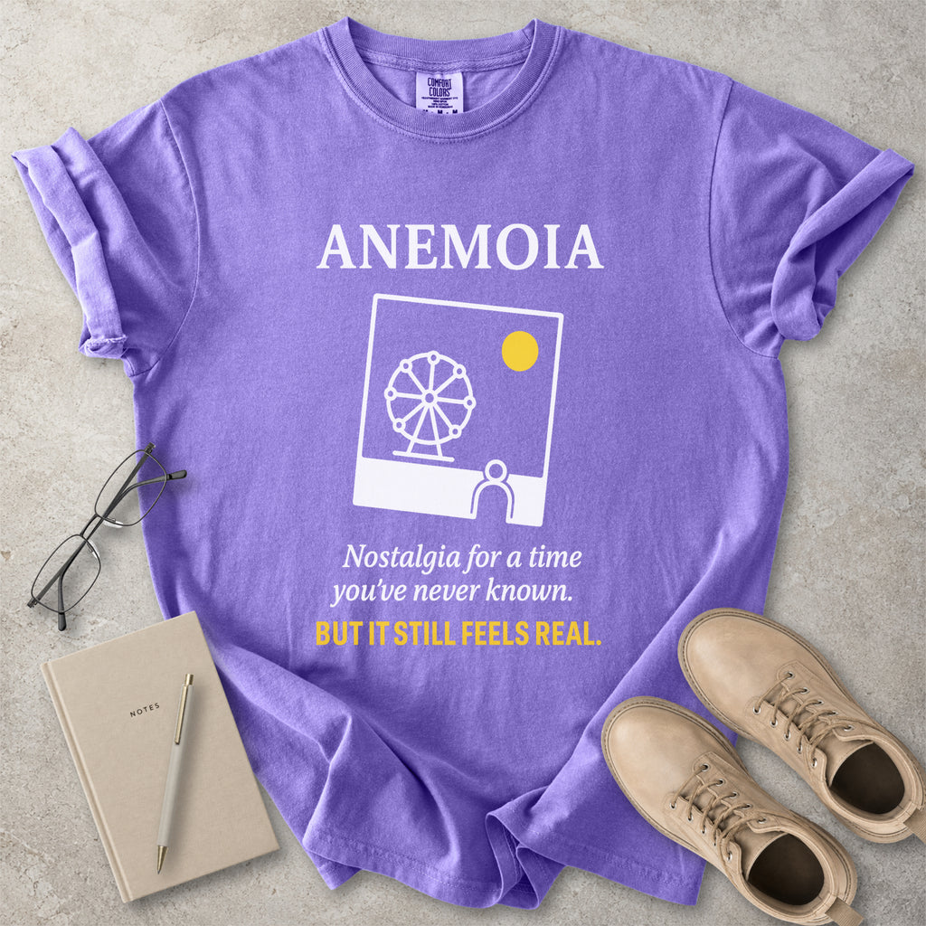 Violet purple Comfort Colors graphic T-shirt with Anemoia text, photo-style ferris wheel design and yellow accent text, styled with notebook, glasses and tan boots