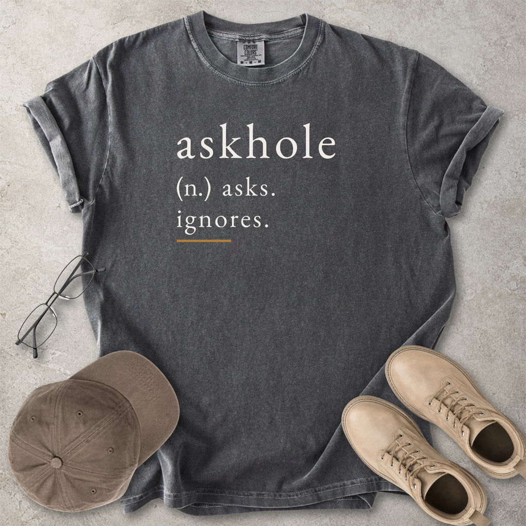 Black Comfort Colors graphic T-shirt with askhole definition text reading asks ignores, styled with notebook, pen, glasses and tan boots