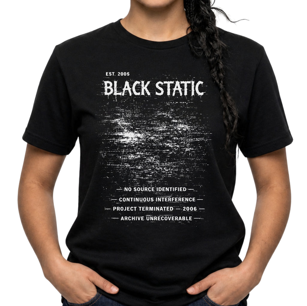 Black Static graphic T-shirt with distressed white typography and static noise artwork on black. A dark archive-band style tee for glitch, cyber grunge, and underground streetwear fans.