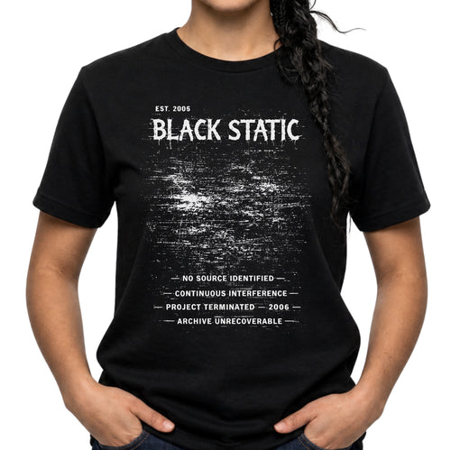 Black Static graphic T-shirt with distressed white typography and static noise artwork on black. A dark archive-band style tee for glitch, cyber grunge, and underground streetwear fans.
