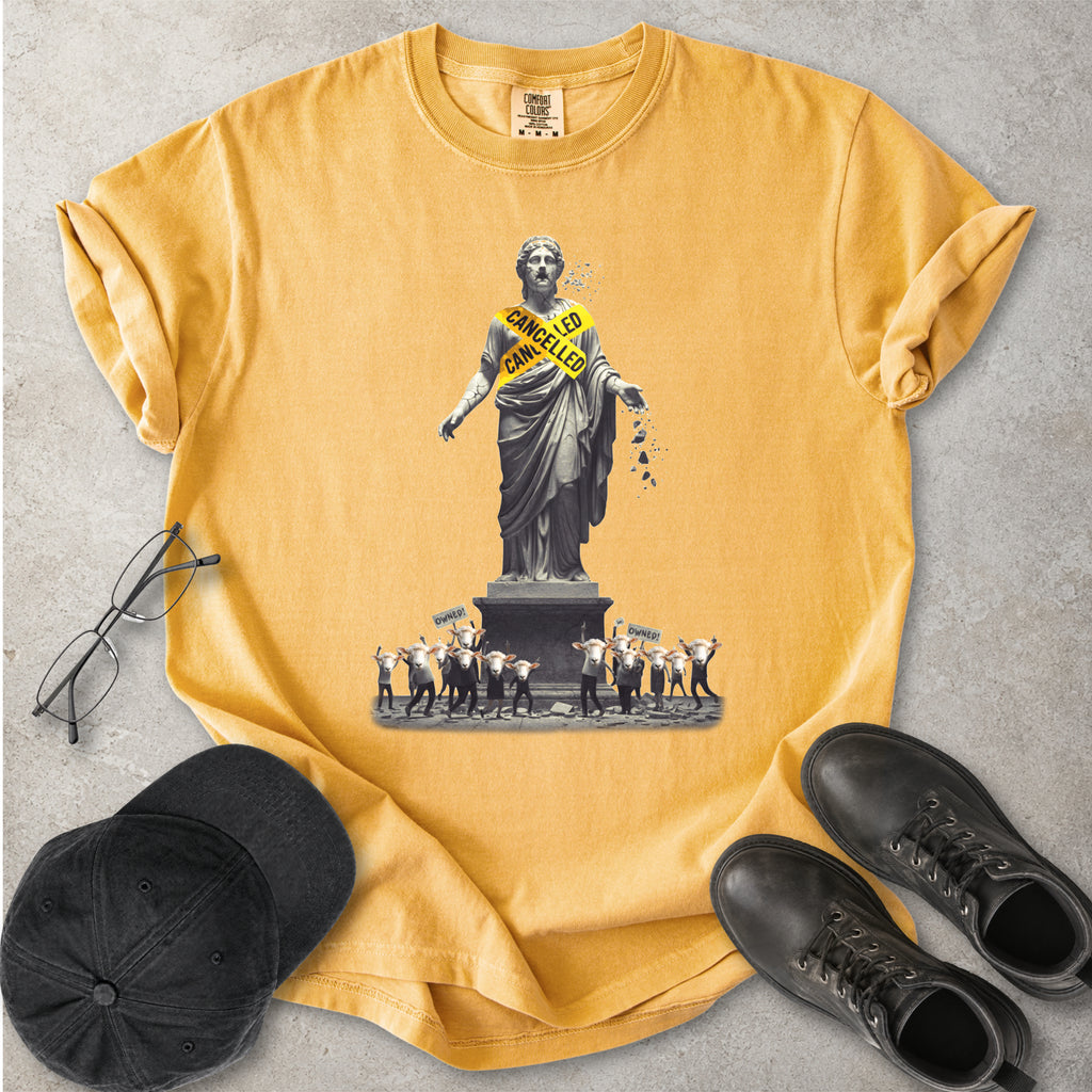 Yellow Comfort Colors graphic T-shirt with cancelled statue and crowd design, styled with black cap, glasses and black boots