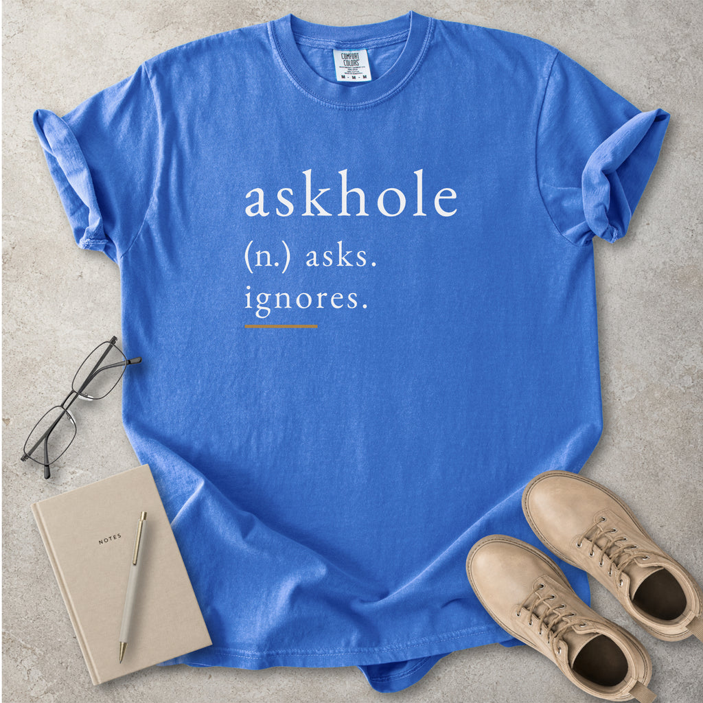 Flo blue Comfort Colors graphic T-shirt with askhole definition text reading asks ignores, styled with notebook, pen, glasses and tan boots