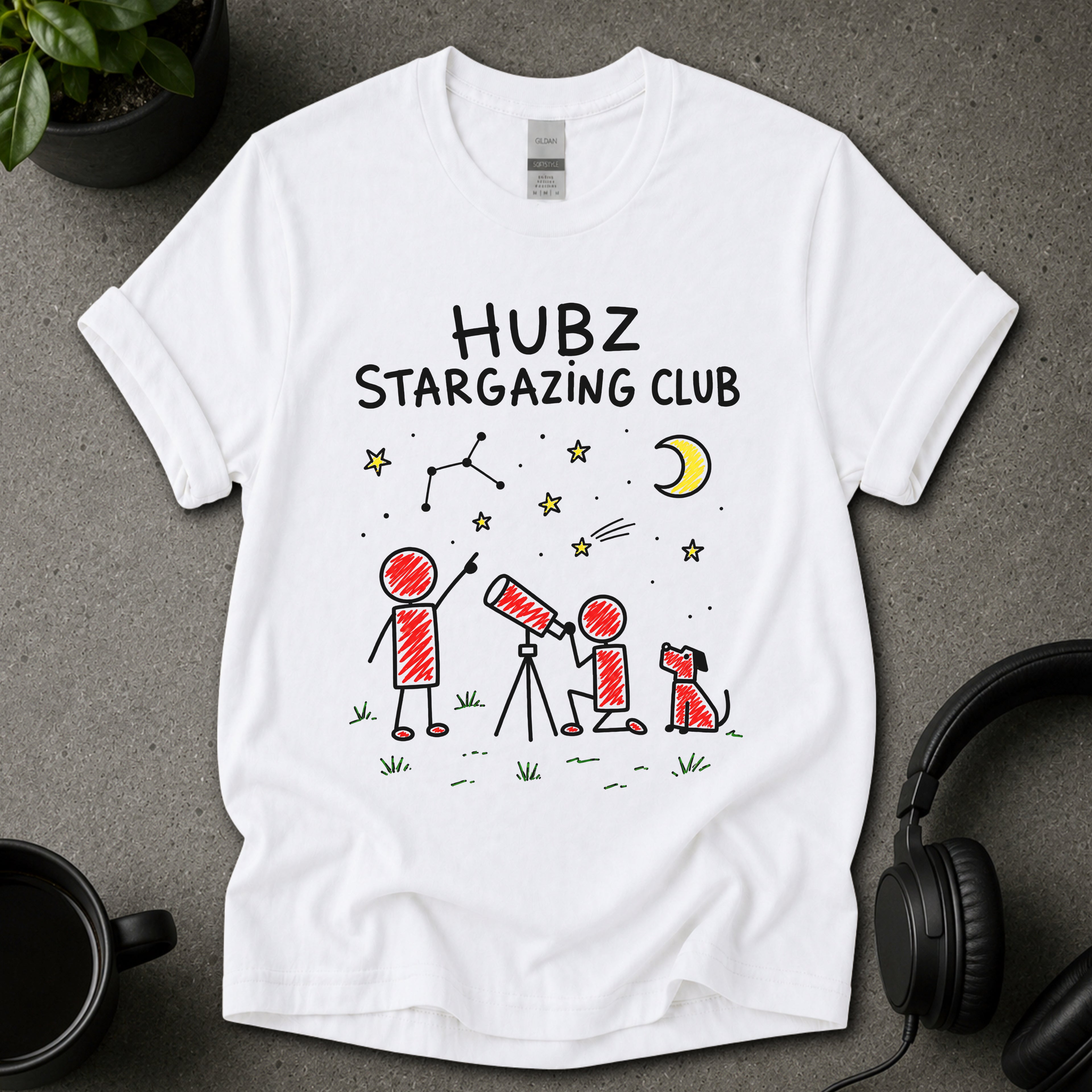 White graphic T-shirt with Hubz Stargazing Club text, moon, stars, telescope, dog and hand-drawn night sky artwork