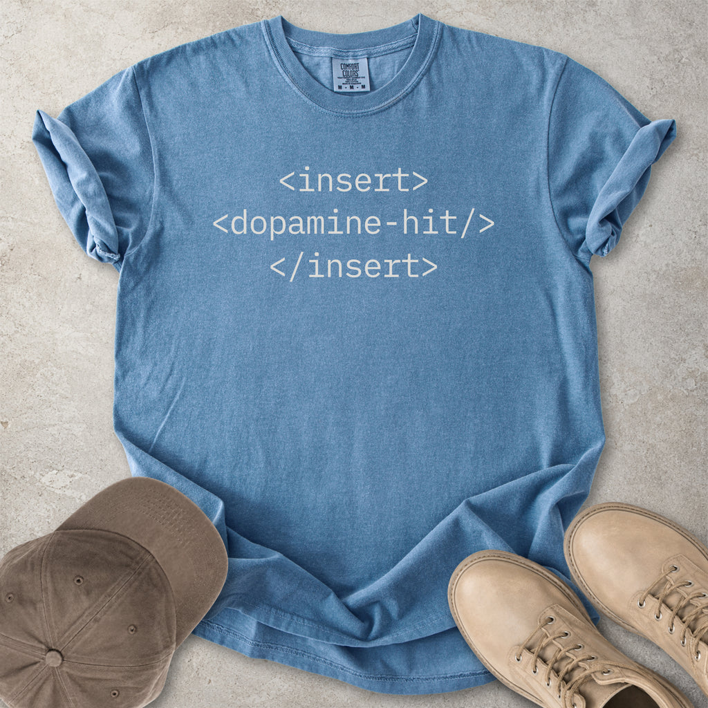 Blue Comfort Colors graphic T-shirt with grey HTML-style text reading insert dopamine hit, styled with brown cap and tan boots