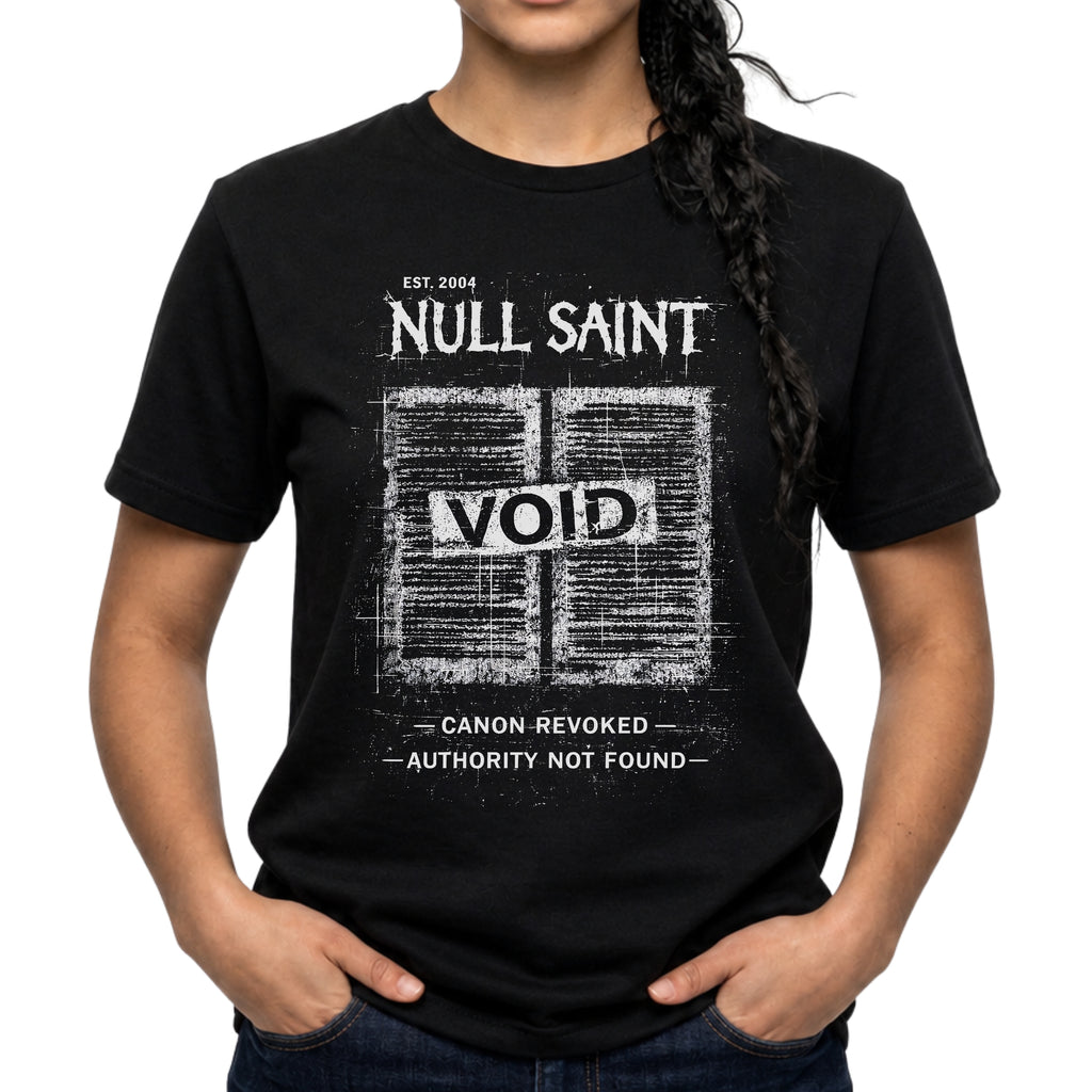 Black Gildan 64000 Softstyle T-shirt featuring a distressed white Null Saint archive graphic with the word “VOID” across the centre and small text reading “canon revoked” and “authority not found.”