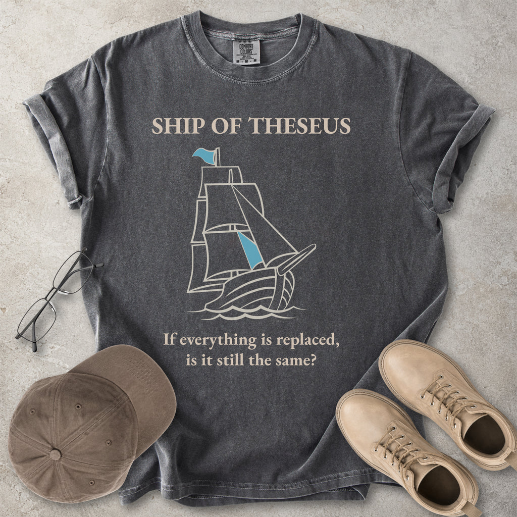 Pepper grey Comfort Colors graphic T-shirt with Ship of Theseus text, line-art sailing ship and the phrase if everything is replaced is it still the same