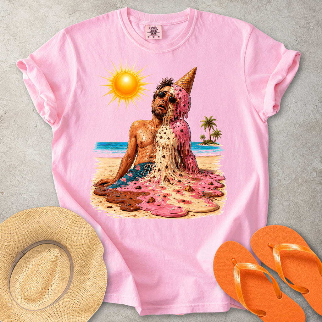 Pink Comfort Colors graphic T-shirt with a melting ice cream man on a sunny beach, styled with straw hat and orange flip flops