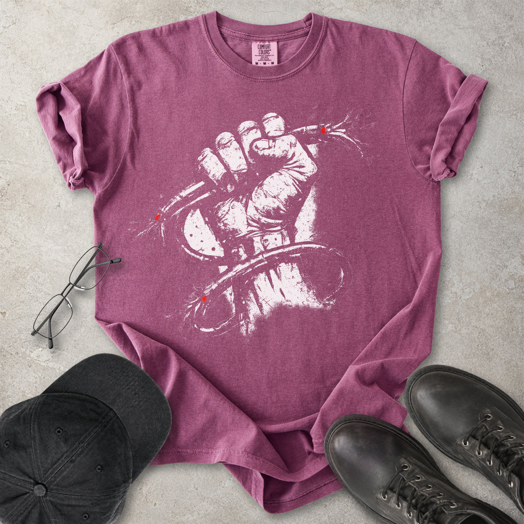 Berry red Comfort Colors graphic T-shirt with distressed white wired fist design and small red accents, styled with black cap, glasses and black boots