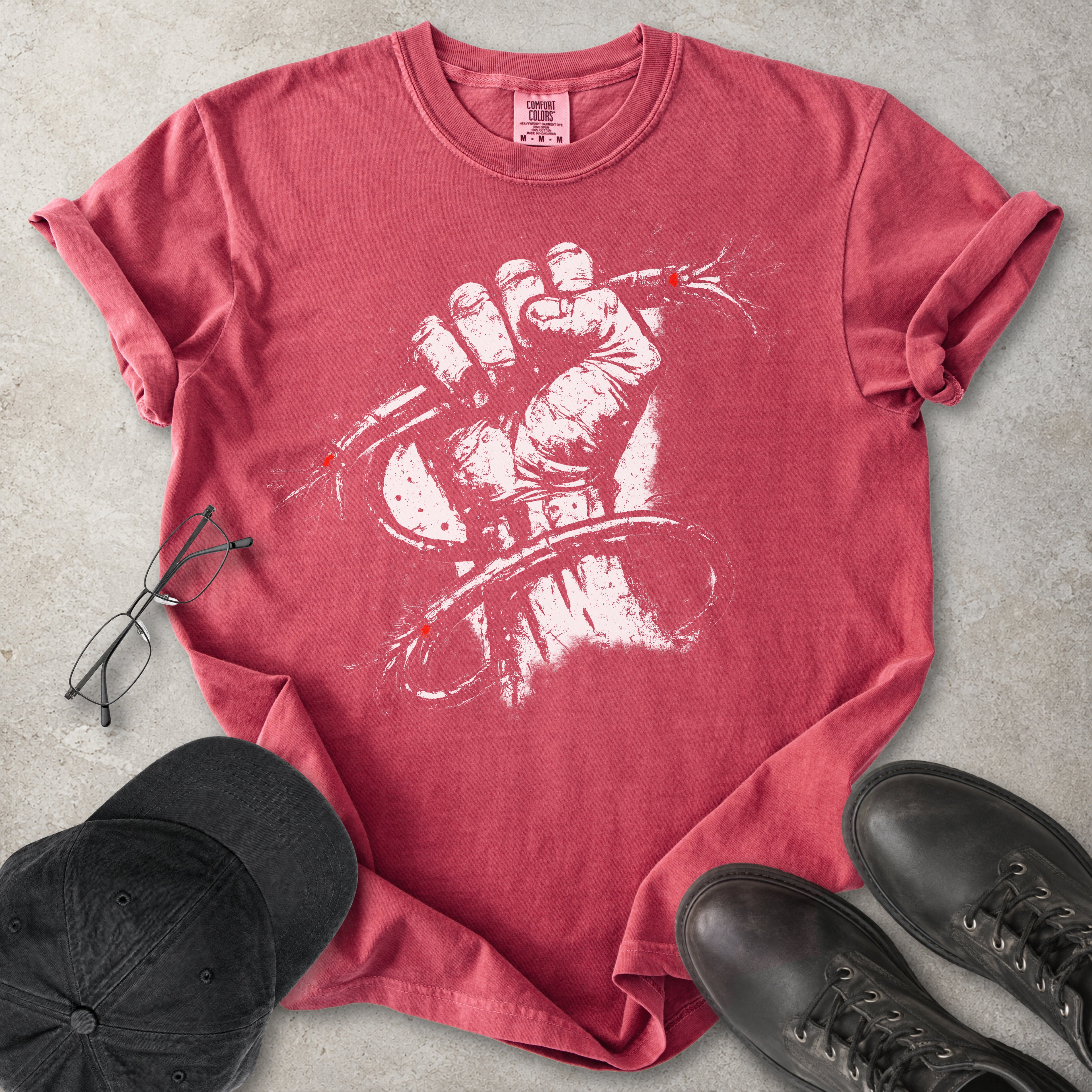 Red Comfort Colors graphic T-shirt with distressed white wired fist design and small red accents, styled with black cap, glasses and black boots