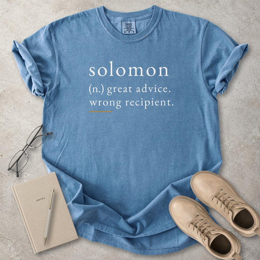 Blue Comfort Colors graphic T-shirt with Solomon definition text reading great advice wrong recipient, styled with notebook, pen and tan boots