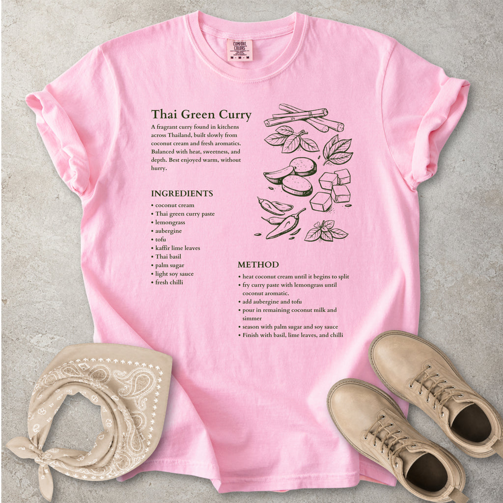 Pink Comfort Colors graphic T-shirt with Thai green curry recipe text, ingredients list, method and food illustration, styled with tan bandana and boots