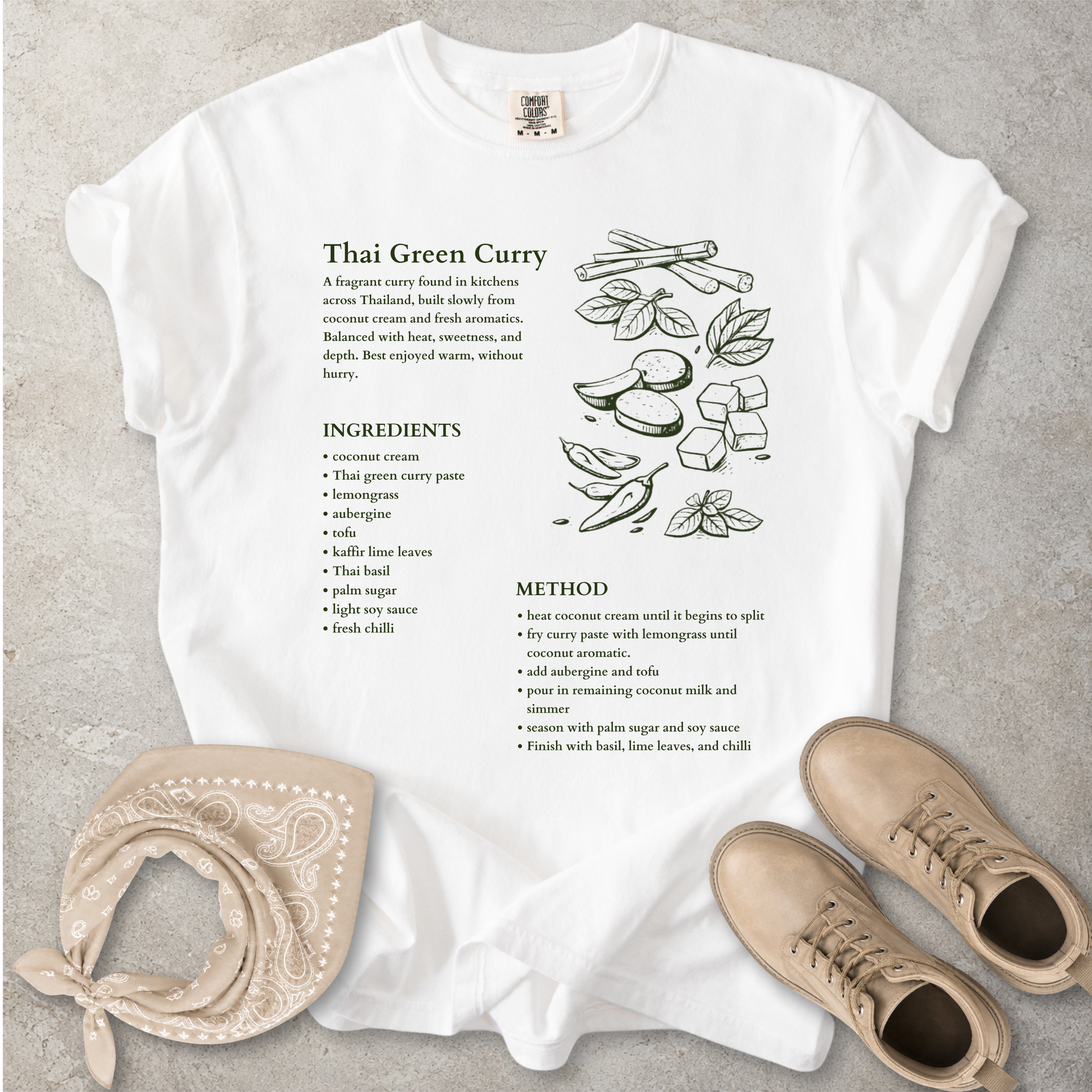 White Comfort Colors graphic T-shirt with Thai green curry recipe text, ingredients list, method and food illustration, styled with tan bandana and boots