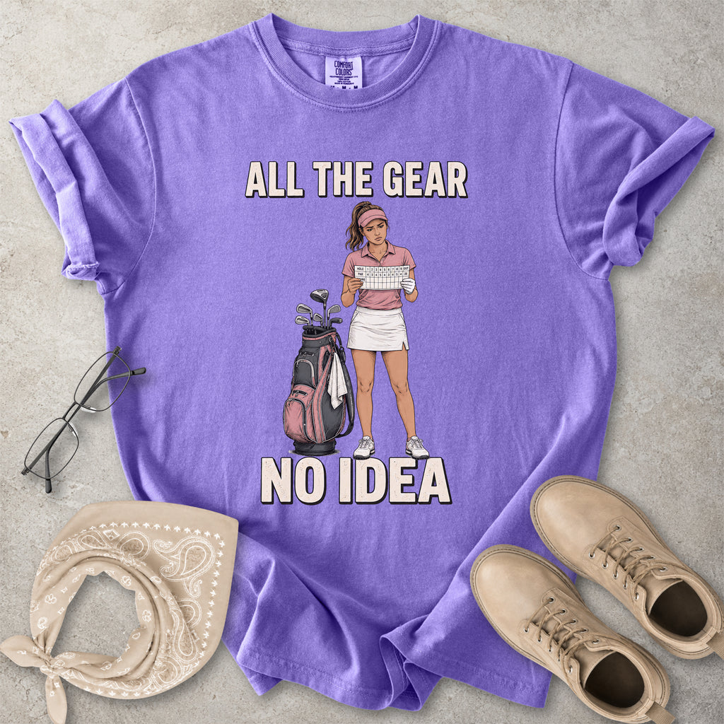 Violet purple Comfort Colors 1717 T-shirt with a funny All the Gear No Idea golf graphic showing a woman golfer holding a scorecard beside a golf bag.