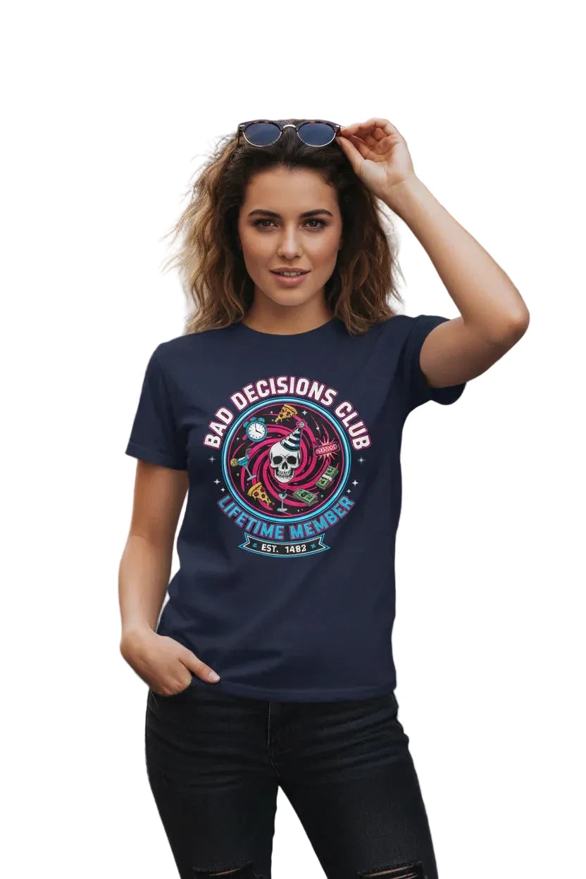 Woman wearing a navy blue t-shirt with a graphic design and text, standing on a street with graffiti in the background.