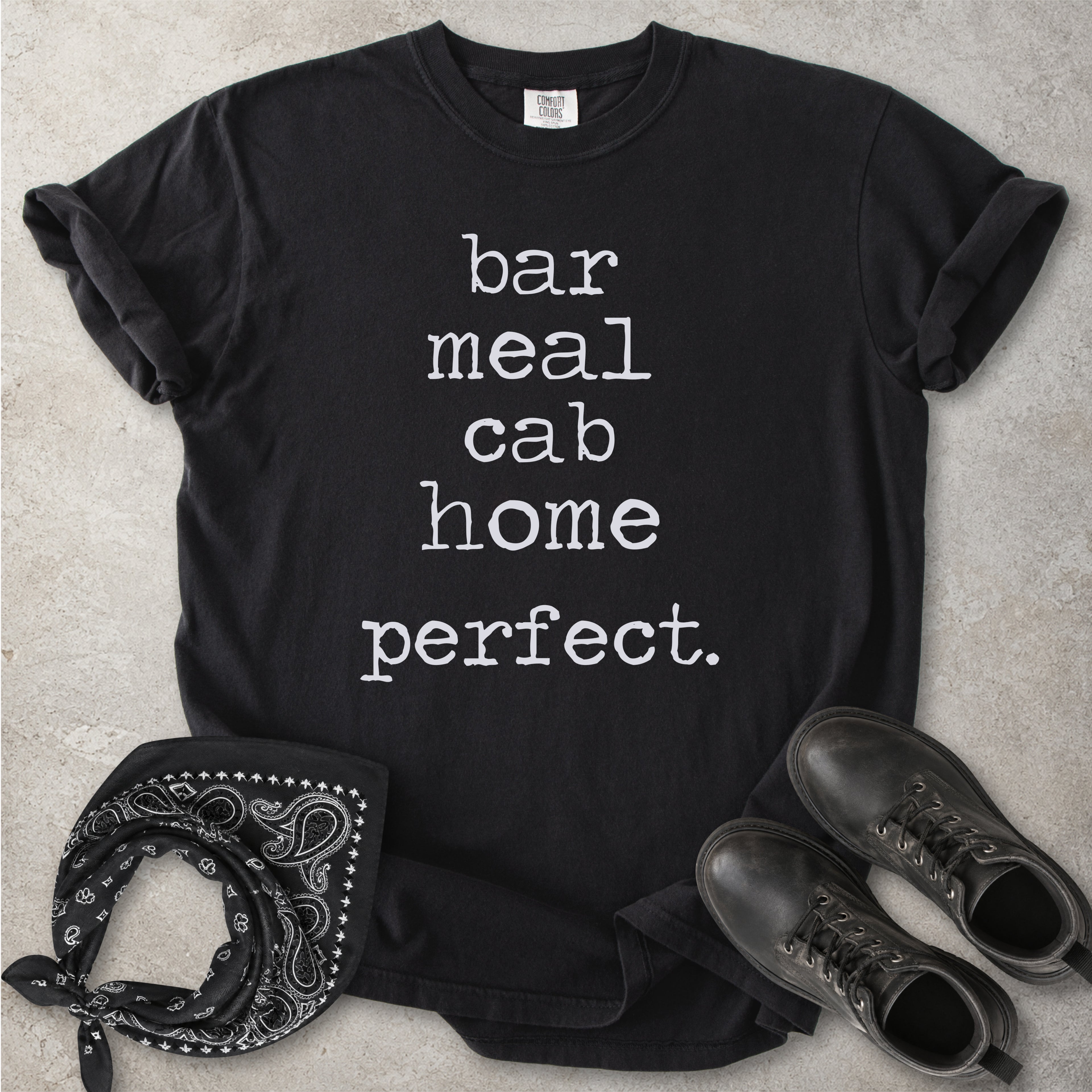 Black Comfort Colors graphic T-shirt with white text reading bar meal cab home perfect, styled with black boots and a black bandana