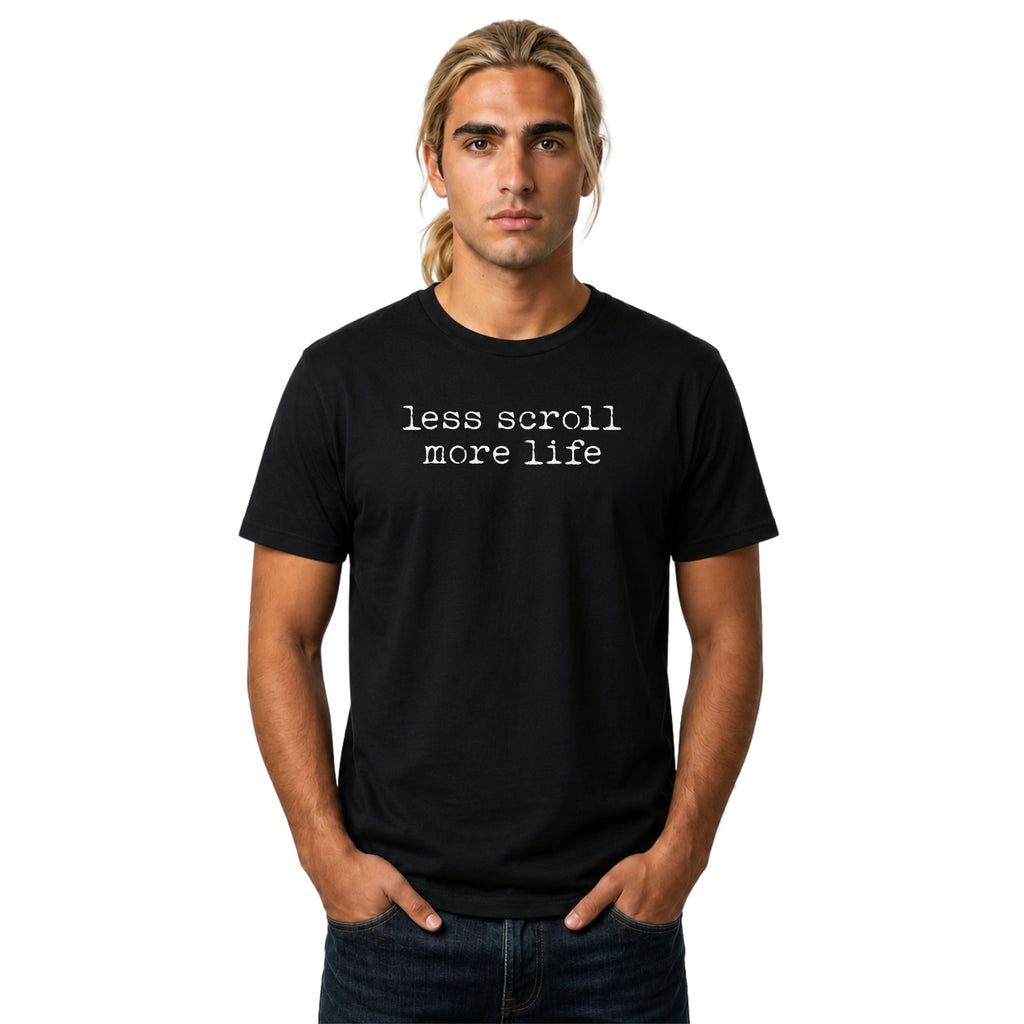 Less Scroll More Life graphic T-shirt with worn white typewriter-style text on black. A clean digital detox tee for screen time, slow living, and mindful everyday wear.