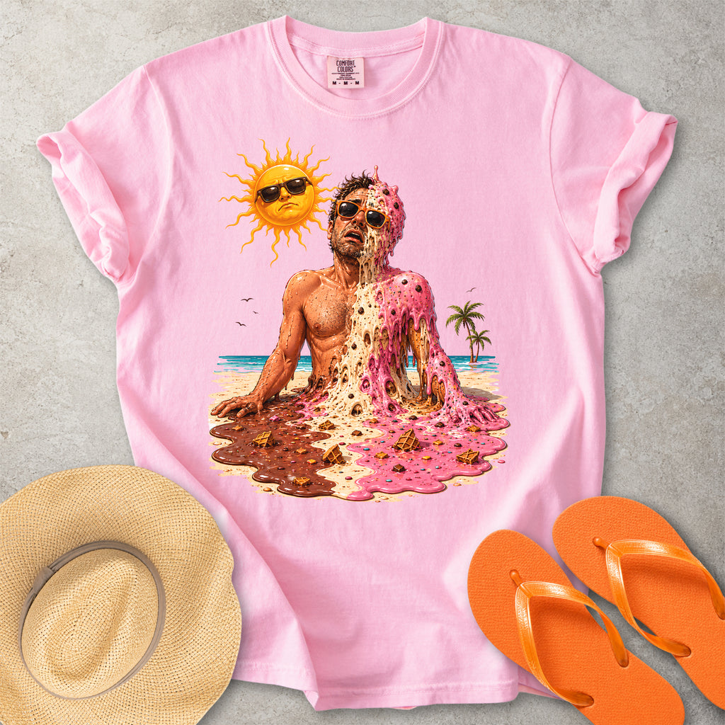 Pink Comfort Colors graphic T-shirt with a melting ice cream man on a sunny beach, styled with straw hat and orange flip flops