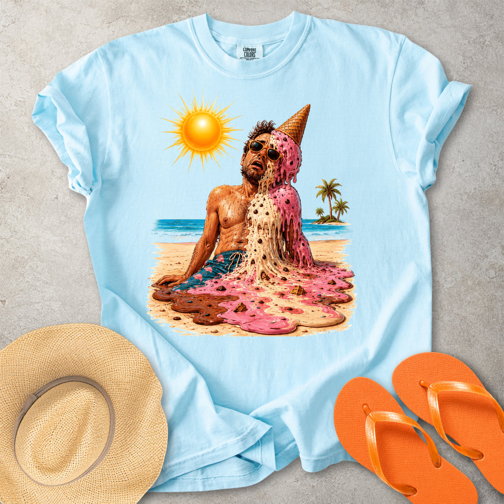 Light blue Comfort Colors graphic T-shirt with a melting ice cream man on a sunny beach, styled with straw hat and orange flip flops