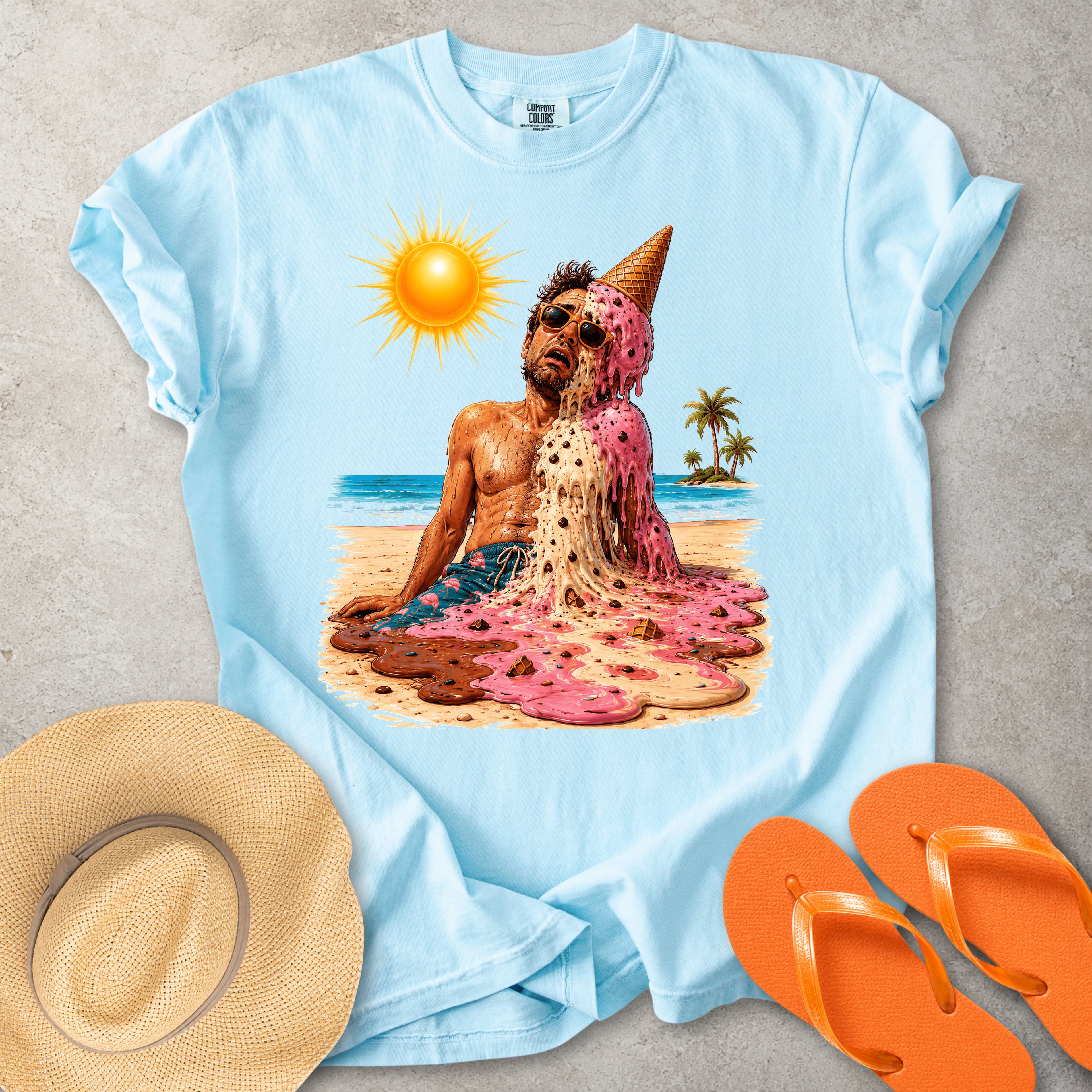 Light blue Comfort Colors graphic T-shirt with a melting ice cream man on a sunny beach, styled with straw hat and orange flip flops