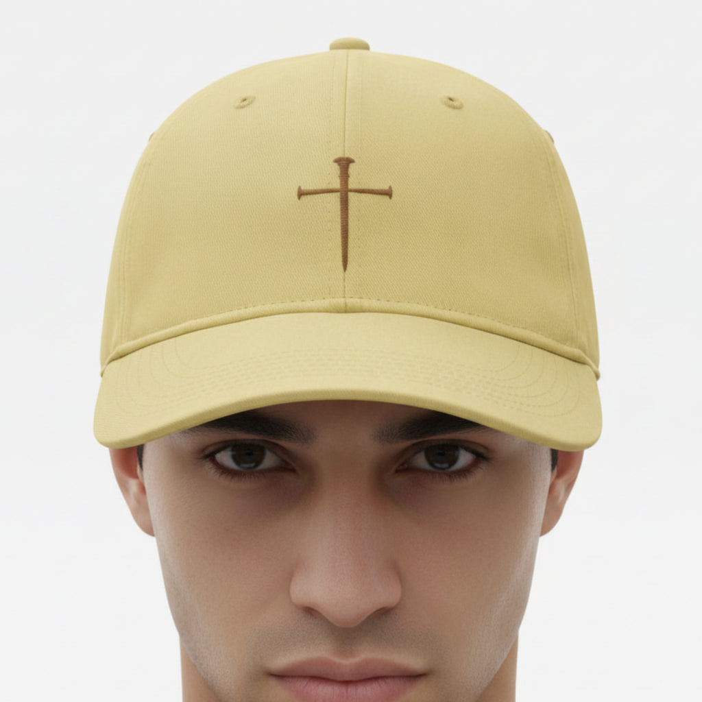 Model wearing the Nail Cross Cap in Butter (pale yellow) — nail cross, crucifixion, Comfort Colors CCWC0 washed christian cap