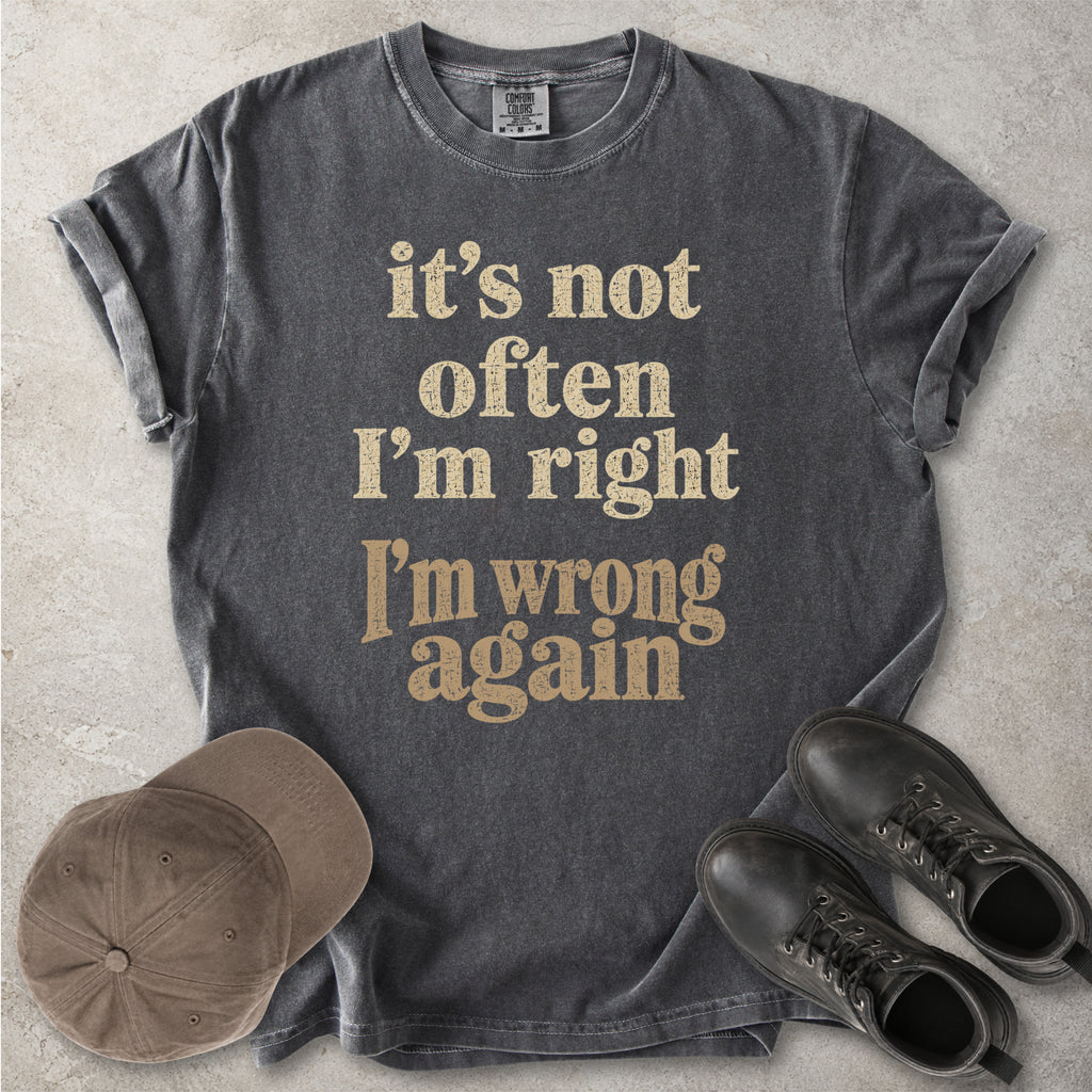 Pepper grey Comfort Colors graphic T-shirt with beige text reading it’s not often I’m right I’m wrong again, styled with a cap and black boots